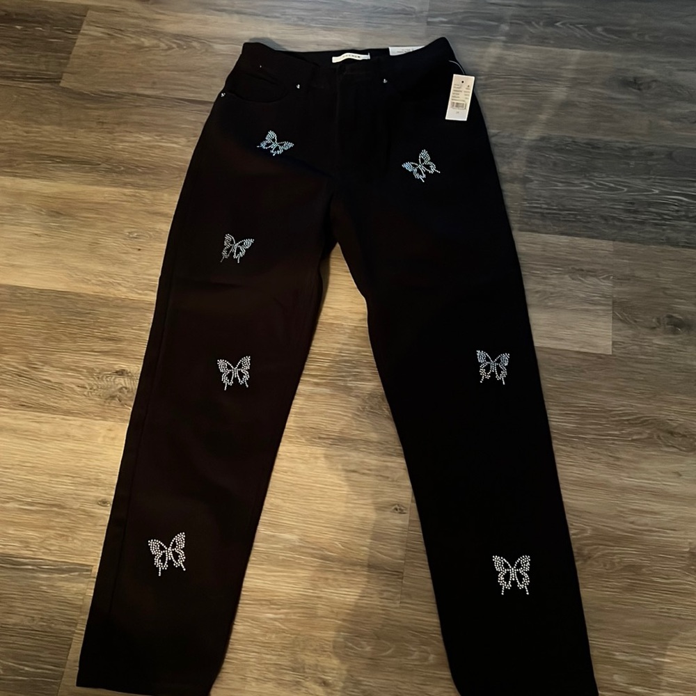 Black jeans with butterfly studs